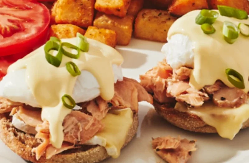 Salmon & Brie with poached egg(s) served on English muffin with roasted salmon, brie cheese, green onions, topped with hollandaise sauce