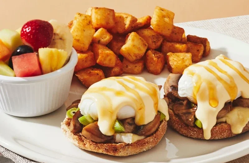 Mushrooms, Brie & Spicy Honey with poached egg(s) served on an English muffin topped with roasted mushrooms, brie, green onions, toppes with