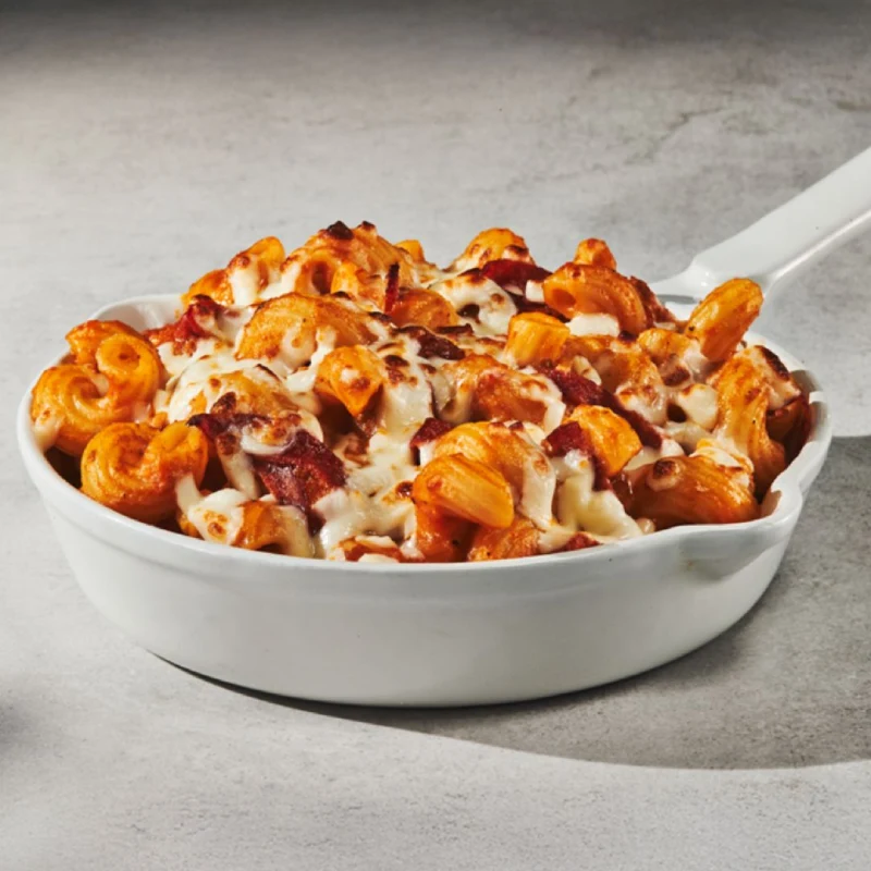 Cavatappi au gratin with bolognese sauce, cream, and pepperoni, served au gratin