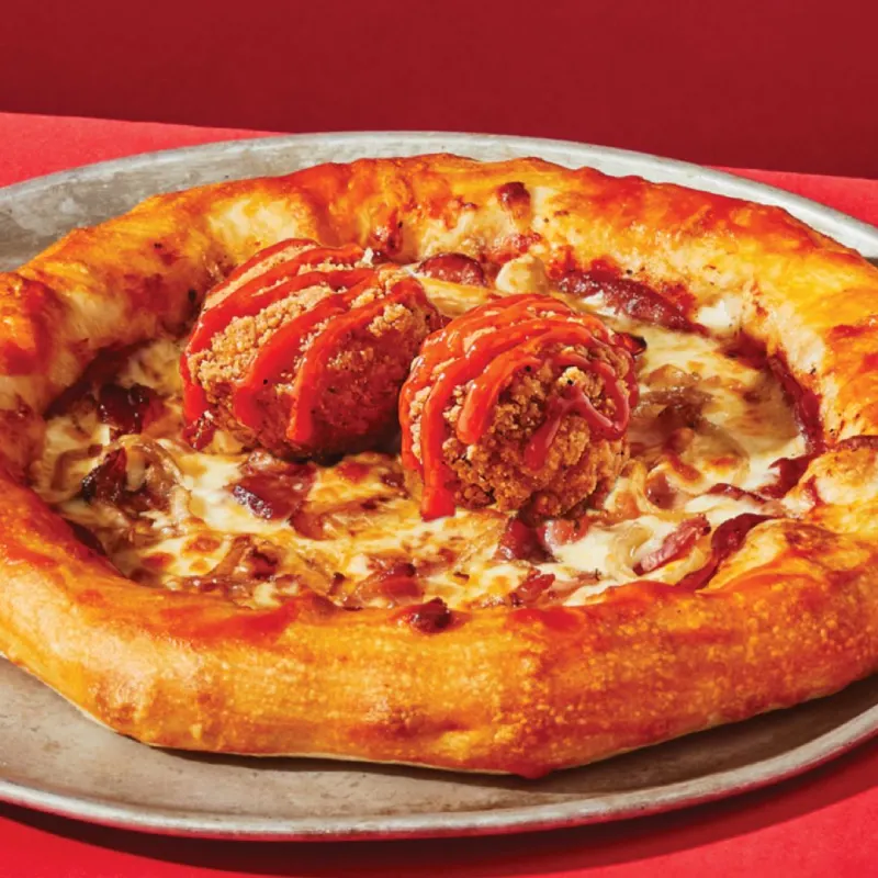 Pompier pizza with stuffed crust brushed with Frank’s RedHot® sauce, pepperoni, bacon, sautéed onions, mozzarella pizza cheese, topped with