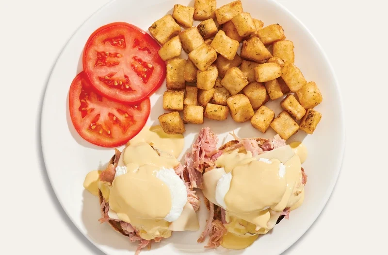 Classic with poached egg(s) served on an English muffin with pulled ham and mozzarella cheese, topped with hollandaise sauce