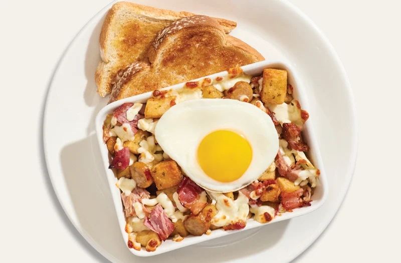 3 viandes avec œuf(s) à ton goût servi(s) sur une délicieuse préparation gratinée composée de pommes de terre assaisonnées, jambon effiloché