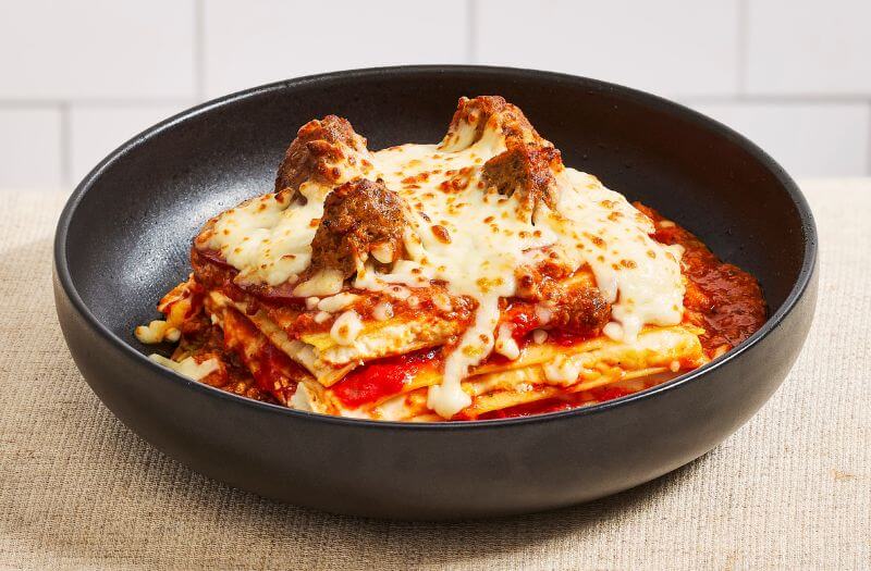 Meatball Bolognese Lasagna with bolognese sauce, ricotta, pork and beef meatballs, pepperoni, Parmesan cheese, and mozzarella cheese
