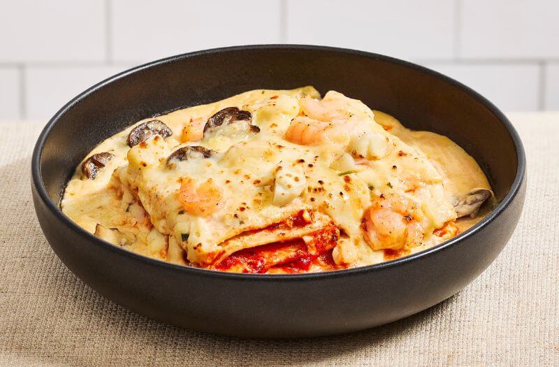 Seafood Lasagna with seafood tomatoe sauce, ricotta, shrimp, seafood mix, mushrooms, Swiss cheese, and mozzarella cheese
